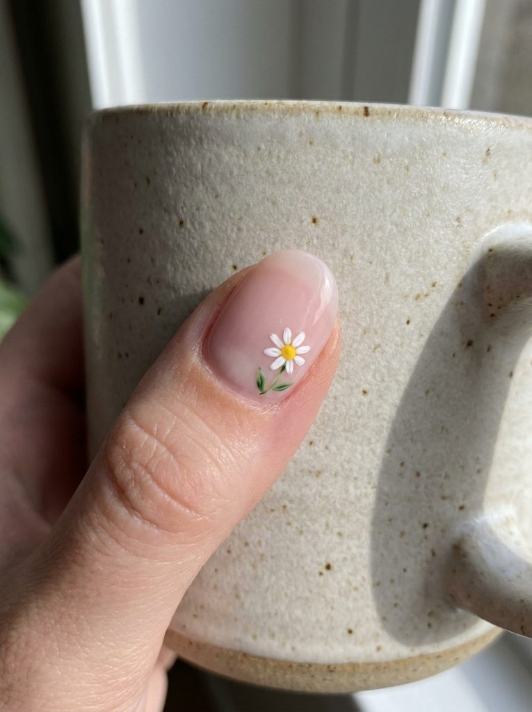 Nail with a single small hand-painted flower accent