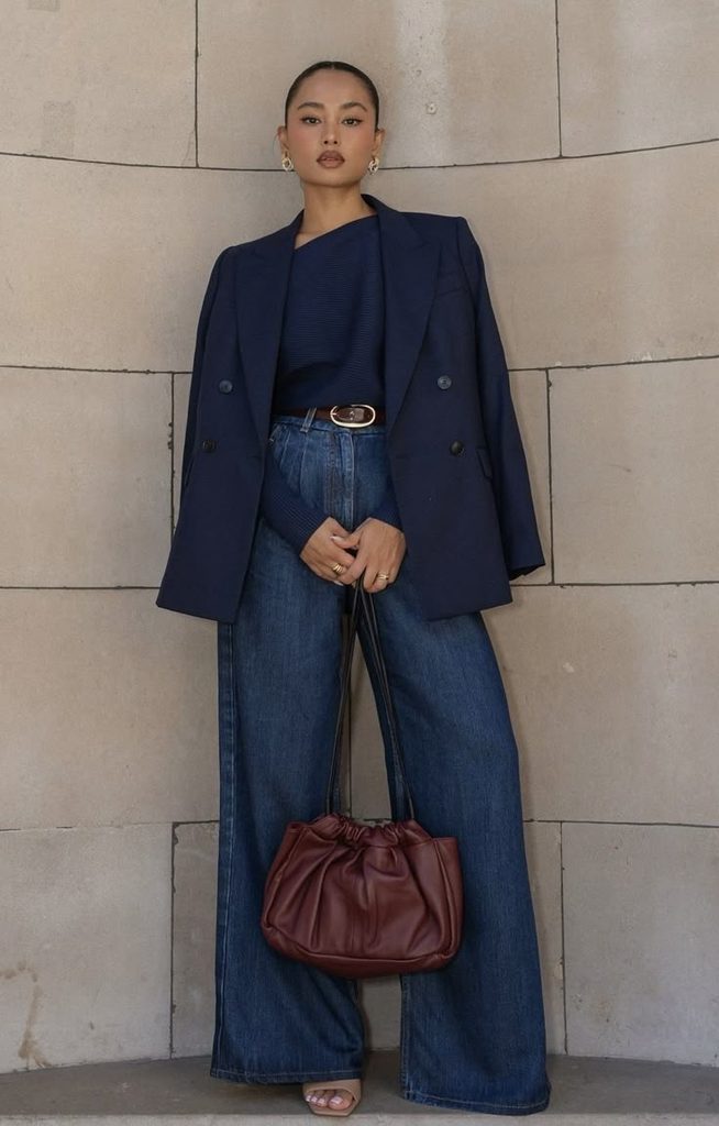 woman wearing navy, denim, cobalt, and slate blue garments arranged in a row